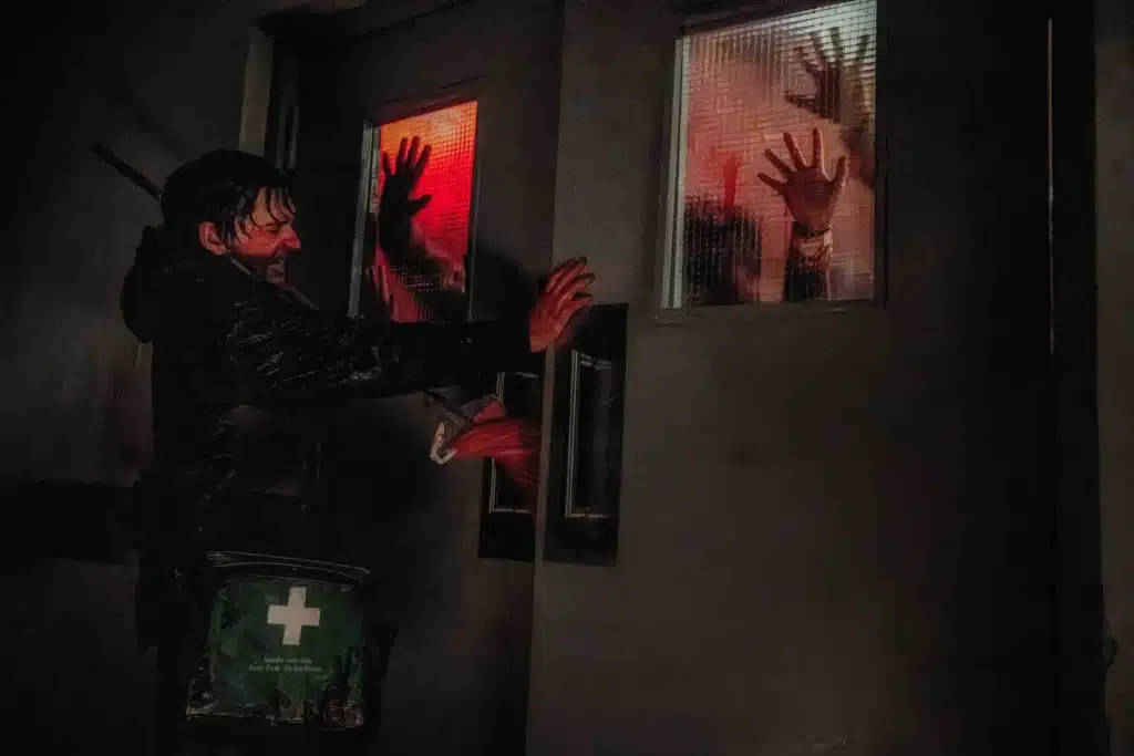 Bryan face à une menace derrière une porte dans Resident Evil (2026)